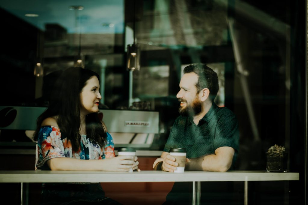 Man and woman talking at a coffee shop