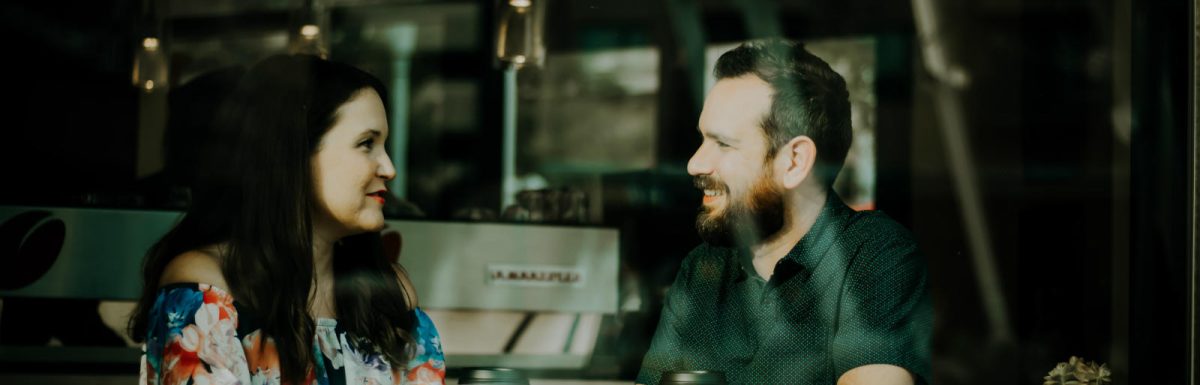 Man and woman talking at a coffee shop