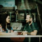 Man and woman talking at a coffee shop