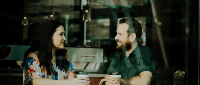 Man and woman talking at a coffee shop