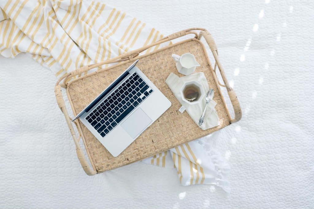 Laptop on a wicker tray